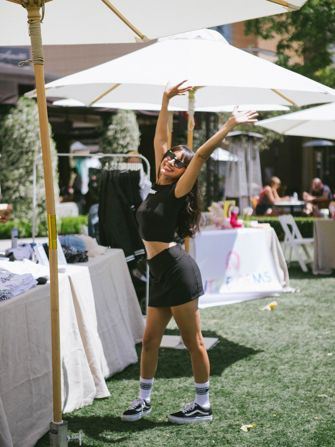 Natalie Alcala, Founder of Fashion Mamas posing with her hands up 